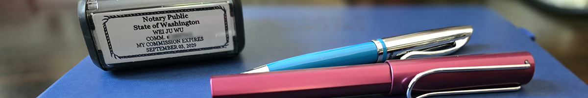 Professional notary setup with stamp, journal, pens, and German/US flags